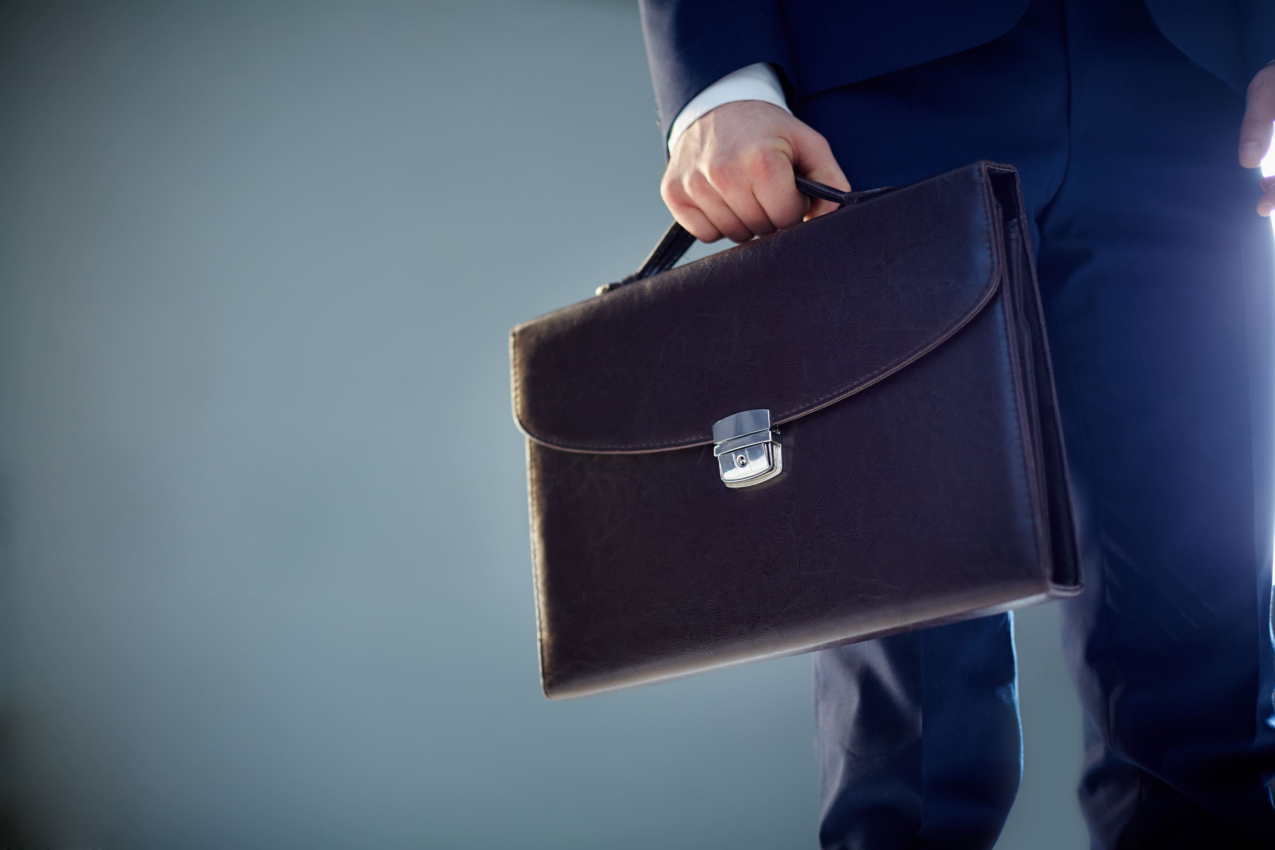 A professional carrying a briefcase, ready for a new role